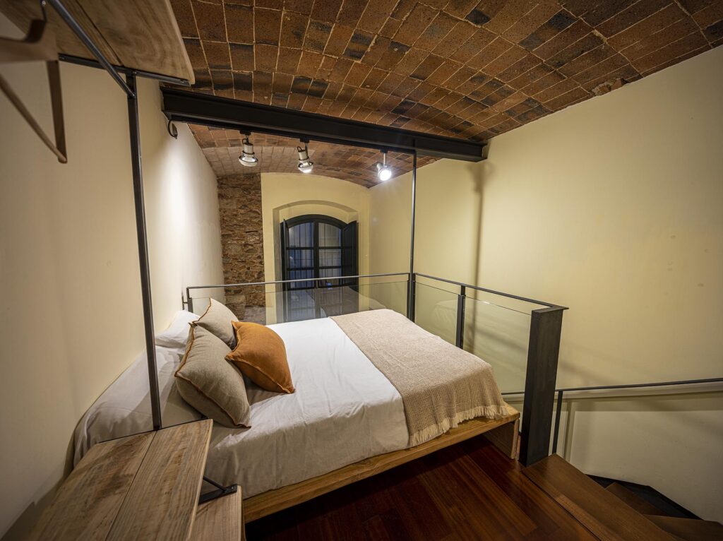 Panoramic view of the bed and staircase of the Santa Rosa Apartment